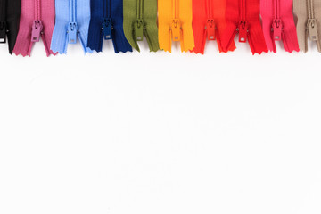 Colorful Zippers in different colors on white background.