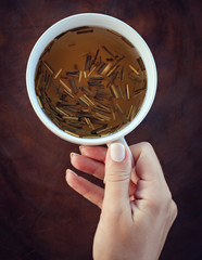 Cup of ginger lemongrass tea on the wooden table