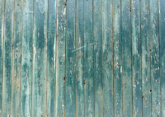 Fototapeta na wymiar Blue weathered wooden fence texture.
