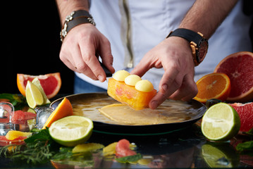 Hand made citrus tart with chef's hand