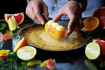 Hand made citrus tart with chef's hand