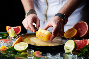 Hand made citrus tart with chef's hand