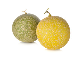 whole honeydew and galia melon with stem on white background