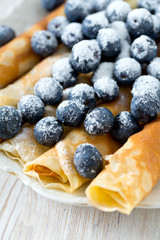 pancakes with blueberries on wooden surface