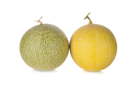 whole honeydew and galia melon with stem on white background