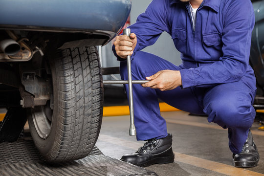 Mechanic Fix Car Tire With Rim Wrench