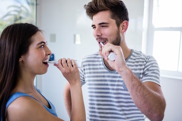 Couple brushing their teeth