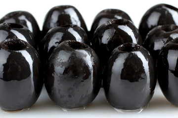 a bunch of delicious and healthy olives, without bones exposed in row on white isolated background