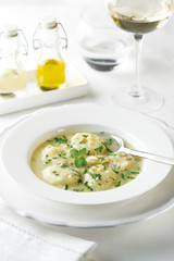 Boiled potatoes in a cream sauce with parsley and almonds