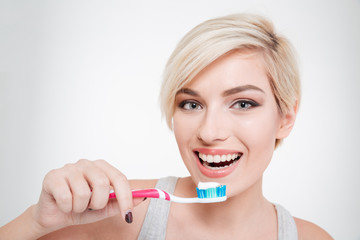 Happy beautiful woman brushing teeth