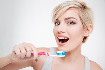 Happy cute woman brushing teeth