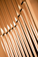Organ pipes closeup in golden tones