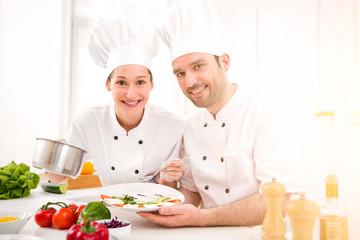 Young attractives professionals chefs cooking together