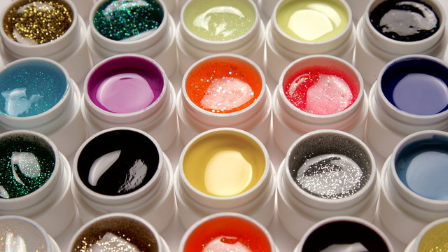 Many colorful nail gel set on white