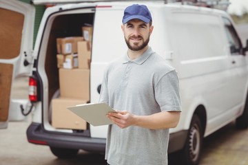 Delivery man writing on clipboard