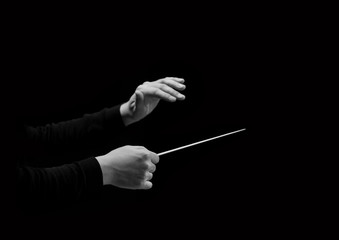 Hands of conductor on a black background in black and white