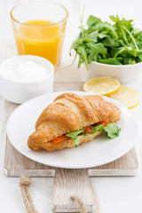 croissant with salted salmon and arugula, vertical