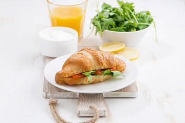 croissant with salted salmon and arugula