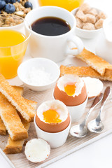 delicious breakfast with soft boiled eggs and crispy toasts