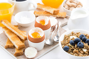 delicious breakfast with soft boiled eggs and crispy toasts