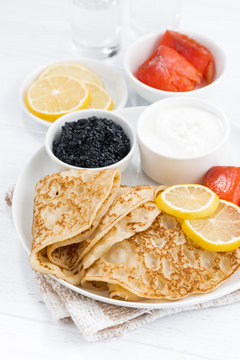 crepes with salted fish, sour cream and caviar, vertical
