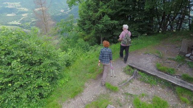 Two older hikers stop to see a beautiful scenery