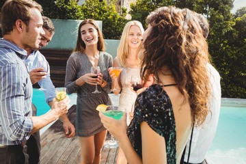 Happy young friends having drinks
