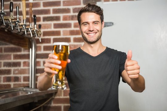 Handsome Man Holding A Pint Of Beer With Thumbs Up