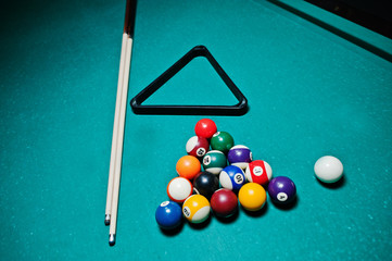 Billiard balls in a pool table at triangle with billiard cue