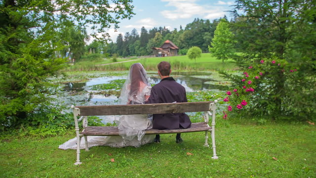 Married couple sitting on a park bench