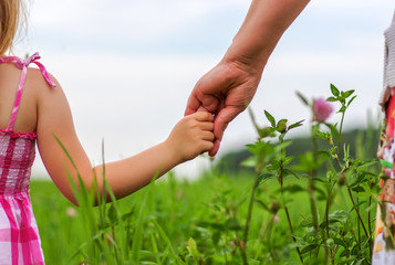 Hands of mother and daughter
