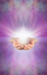 Receiving a Reiki Attunement - female cupped hands with burst of white energy above on a beautiful intricate feminine purple pink energy formation background with plenty of copy space