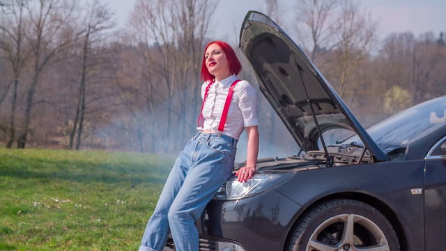 Posing on the front of a broken car 