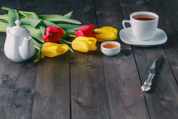 Breakfast table setting with tulip flowers