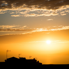 Silhouette of house with antennas