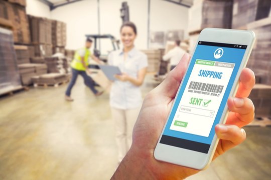 Composite image of hand holding smartphone