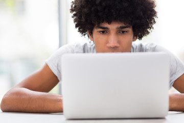 Obraz na płótnie Canvas Afro man using laptop 