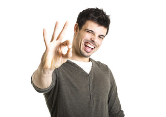 Young man showing Ok sign over white background