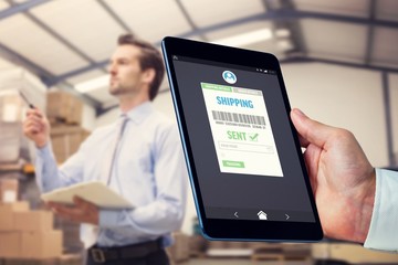 Composite image of man using tablet pc 