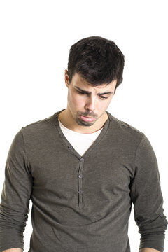 Portrait of young sad man over white background