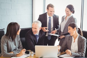 Businesspeople interacting in conference room