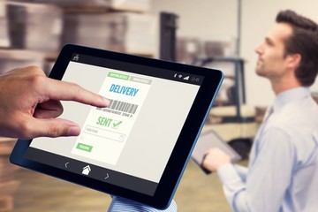 Composite image of man using tablet pc 