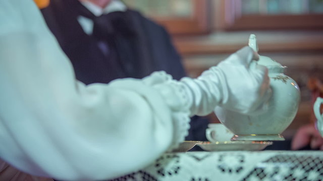 Lady giving a tea t the man 