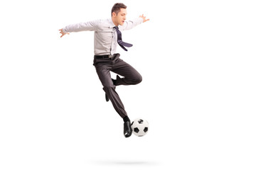 Young businessman playing football
