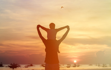 Fototapeta premium happy father and son on sunset beach