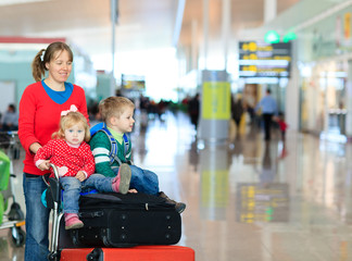 family with two kids travel in the airport