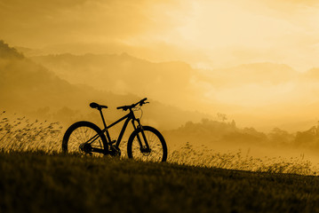 Fototapeta na wymiar Silhouette Mountain bike on beautiful landscape, Silhouette Bicycle sunset on beautiful landscape mountain nature