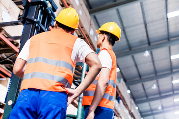 Worker team taking inventory in logistics warehouse