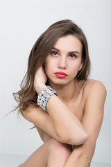 Naklejka premium close-up portrait of a beautiful girl with red lips, brilliant bracelet on the wrist. Red Sexy Lips and Nails closeup