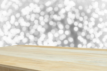 wood table in front of white bright bokeh lights